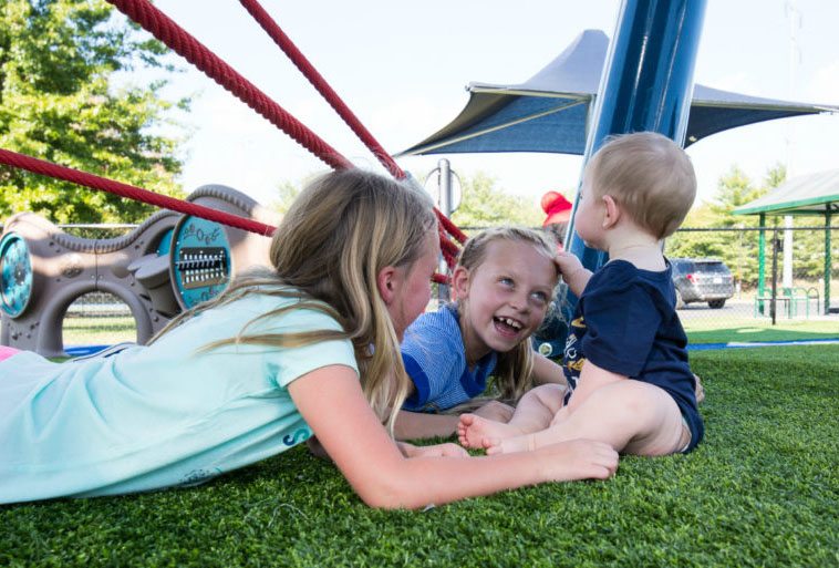 Mt. Kids playing at Mt. Ton of Fun featuring Playground Grass by ForeverLawn