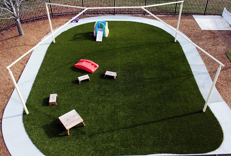 Playground Grass by ForeverLawn covering play mounds at Security Benefit Academy in Topeka, Kansas