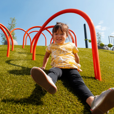 Girl sliding down PG grass