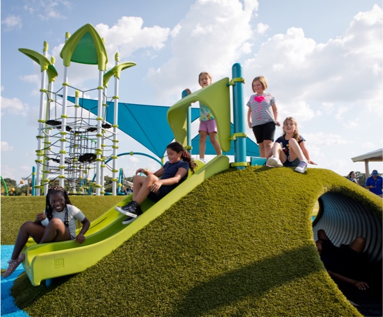 Carrollwood Village Park featuring a PlayMound™ covered in Playground Grass synthetic turf by ForeverLawn